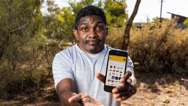 Indigemoji Graphic designer Graham Wilfred Jnr with the app. Picture: Indigemoji/Kickstarter