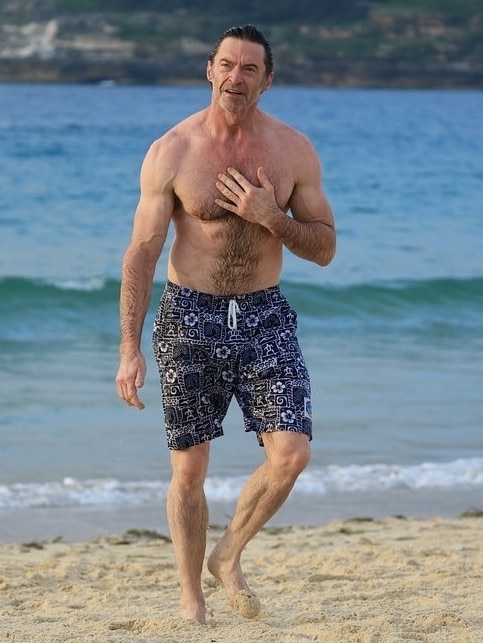 Jackman walks back up the beach after taking a dip. Picture: BACKGRID Australia