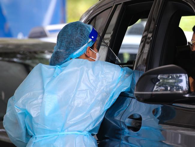 SYDNEY, AUSTRALIA - NewsWire Photos, DECEMBER 20 2021: People are seen lining up to get a Covid-19 test at the Burwood Covid Testing clinic in Sydney ahead of Christmas as positive cases continue to rise in NSW. Picture: NCA Newswire / Gaye Gerard