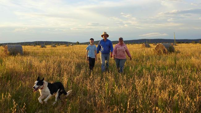 Farmers David and Emma Kalisch with their son Jackson and dog Juno walk through their once parched property. Picture: Joel Pratley