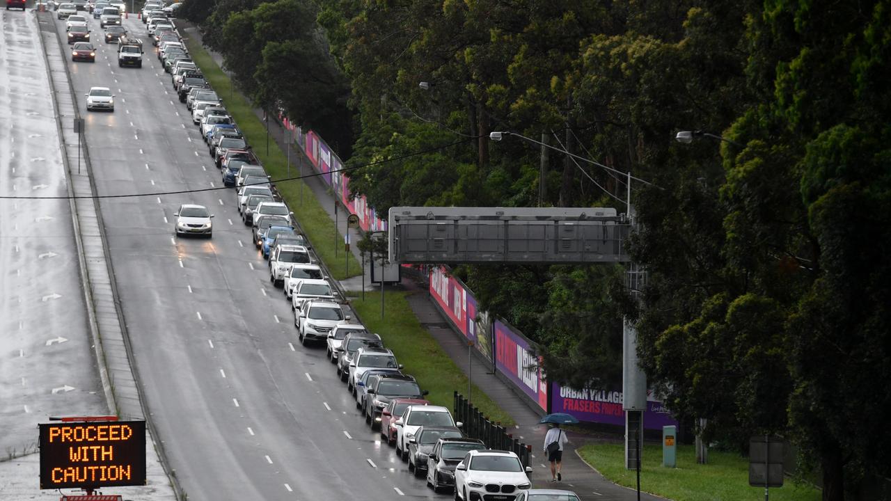 Members of the public queue in their cars for Covid-19 PCR tests at a clinic at North Ryde in Sydney, Wednesday, December 29, 2021. AAP Image/Mick Tsikas