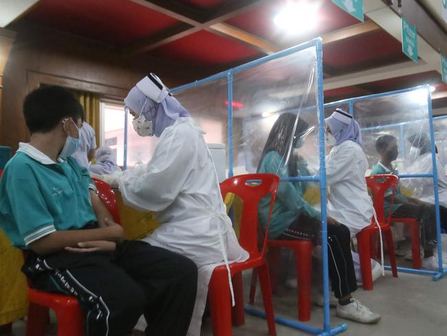 Medical workers administer doses of the Pfizer vaccine in southern Thailand's Pattani province. Picture: AFP