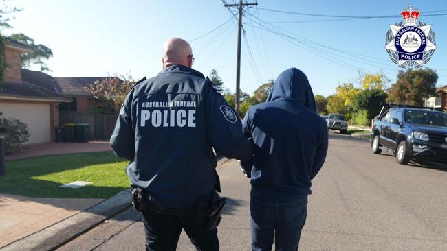 An Australian Federal Police officer arrests Jay Je Yoon Jung, the alleged mastermind behind the encrypted messaging platform “Ghost” used by criminals. Picture: AFP