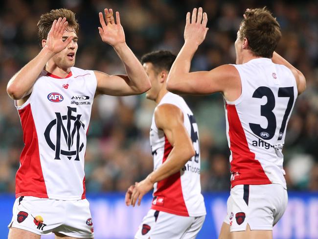 Dom Tyson of the Demons is congratulated by team mate Aaron Vandenberg.