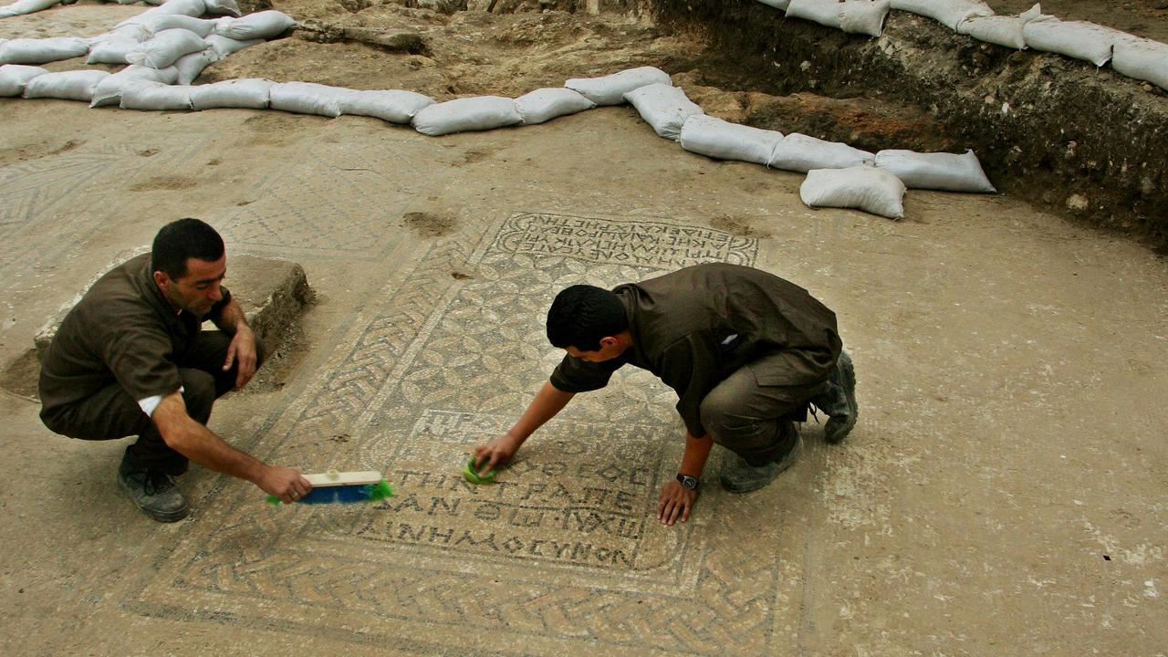 Israeli prisoners clean a section of a Christian mosaic floor dating to the third or fourth century AD, in the compound of the Megiddo prison. Picture: AP