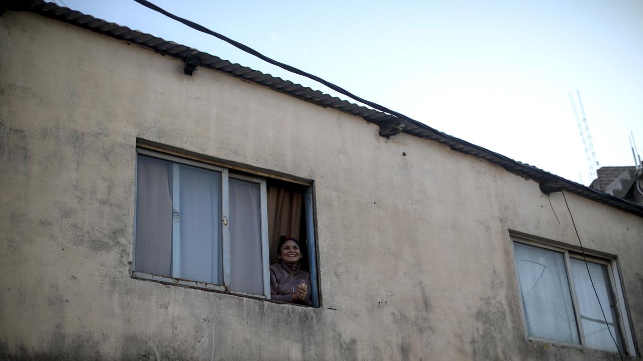 A woman looks out her window during a government-ordered lockdown to curb the spread of coronavirus at a slum in Buenos Aires, Argentina on Sunday, April 26, 2020. Picture: Natacha Pisarenko/AP