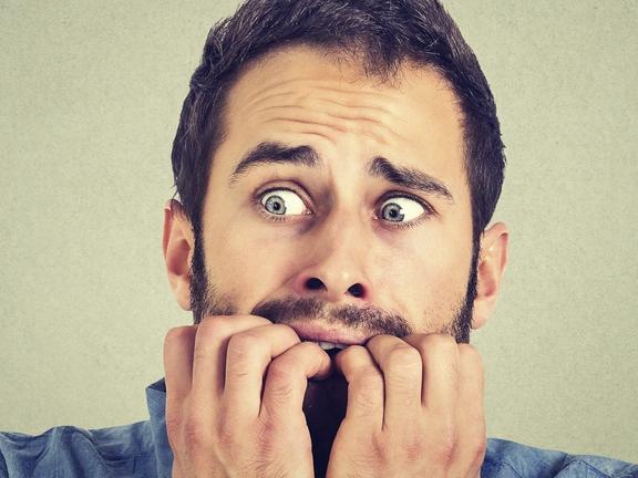 Portrait anxious young man biting his nails fingers freaking out, frightened, generic, scared