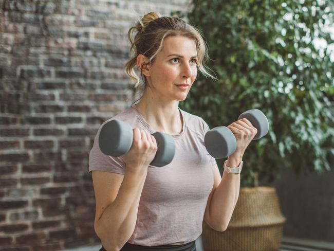 Women at home during pandemic isolation doing workout to stay in shape