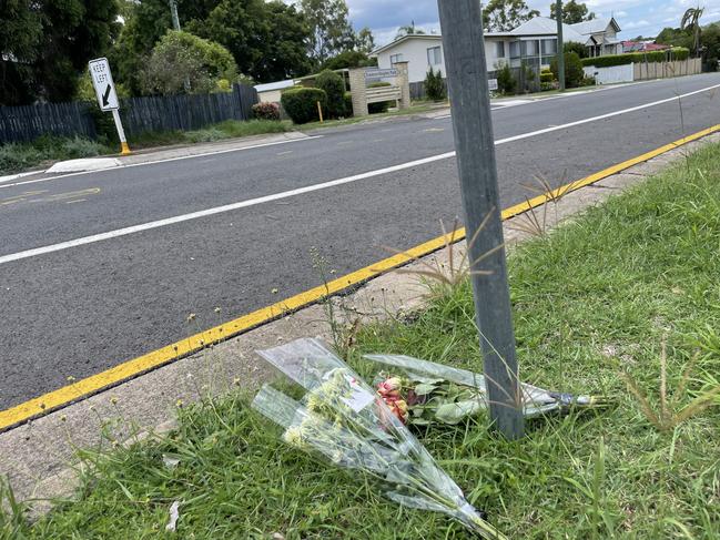 Memorial flowers on Robertson Road, Raceview, on January 5, beside the crossing (pictured) where the incident occured. Picture: Nicola McNamara