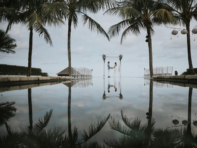 Mang Khris of MAJAartisan used the reflection of the water at a resort pool to capture this couple in Sinaran Surga Uluwatu, Bali, Indonesia.