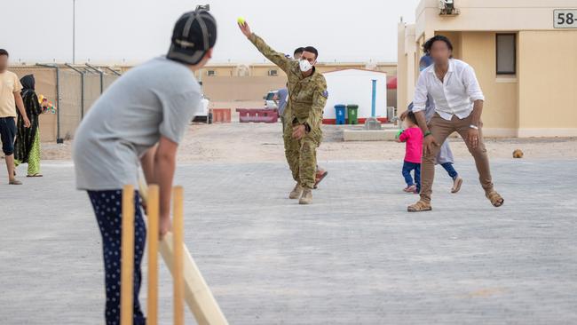 Australian Army Private Lachmaiya plays cricket with Afghan evacuees at the temporary camp in Australia's main operating base in the Middle East. Picture: ADF