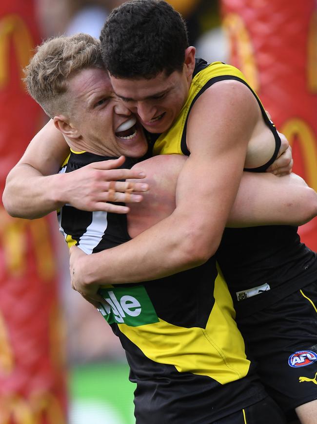 Josh Caddy and Jason Castagna of the Tigers react after Castagna kicked a goal during the second AFL preliminary final. Picture: AAP Image/Julian Smith