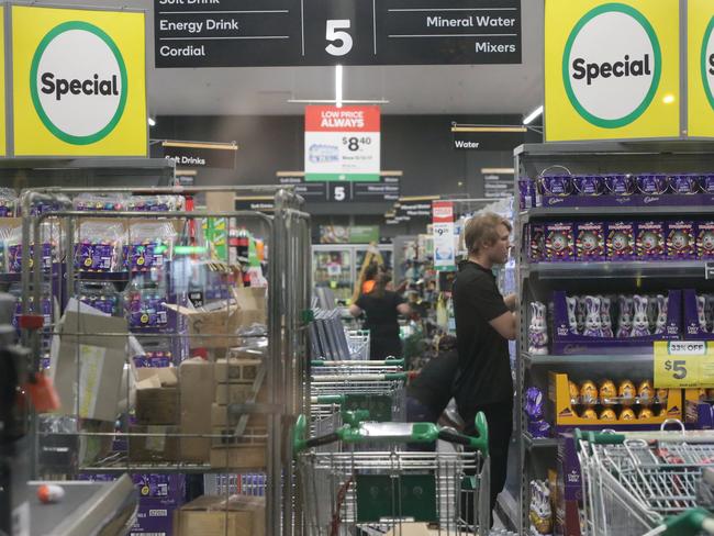 Woolworths workers working to restock shelves amid the coronavirus outbreak and panic buying. Picture: Bill Hearne