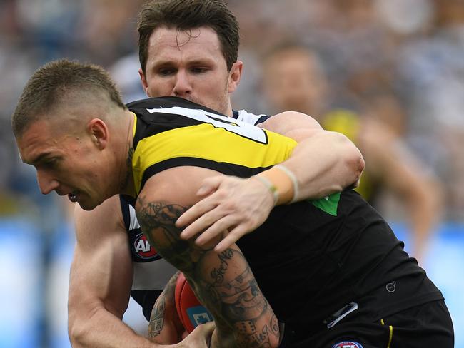 Dustin Martin of the Tigers (left) and Patrick Dangerfield of the Cats contest during the Round 21 AFL match between the Geelong Cats and the Richmond Tigers at Simonds Stadium in Geelong, Saturday, August 12, 2017. (AAP Image/Julian Smith) NO ARCHIVING, EDITORIAL USE ONLY