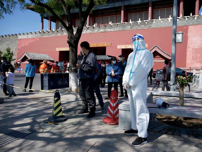 People queue for a swab test to be tested for coronavirus near the entrance of the Forbidden City in Beijing. Picture: AFP