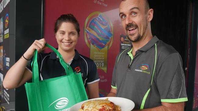 Caboolture Sports Club Venue &amp; Culture Manager Suzy Vercoe and Executive Chef Anthony Gavin with a chicken parmy which was part of the club’s takeway menu introduced during COVID-19.