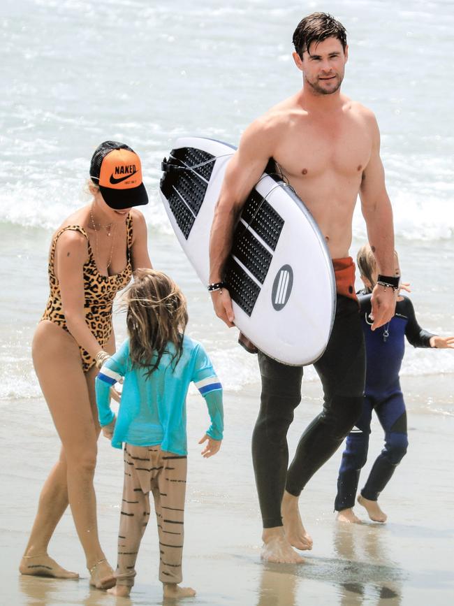 With their kids at the beach in Byron Bay last month. (Pic: Media Mode.com)