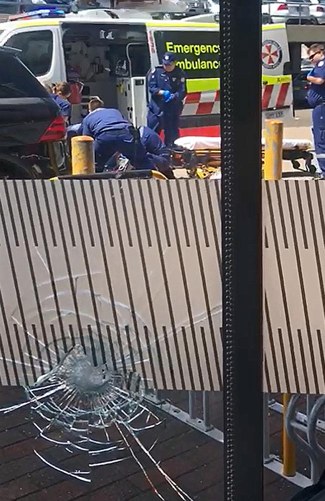 Screen grabs of the video Mr Nascmanto took through the shot-up window of Fitness First of paramedics at work in the carpark.