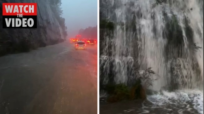 Rain cascades over rock face on M1 at Gosford