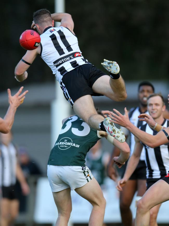 Euroa’s Andrew Bell soars over the top of Echuca’s Brady Simpson.