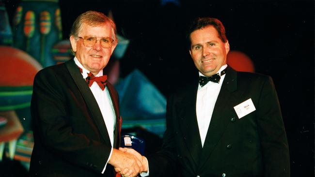 Paynter Dixon managing director West Smith (L) congratulates Airlie Beach hotel general manager Mark Bell on the hotel's QHA redevelopment award. 24/10/2000