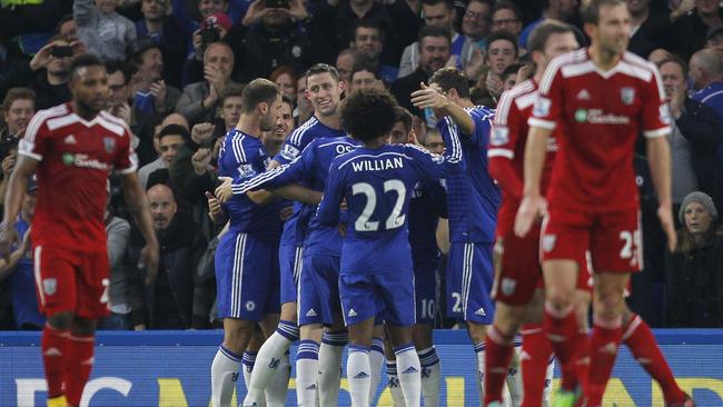 Chelsea’s Belgian midfielder Eden Hazard (C) celebrates with teammates.