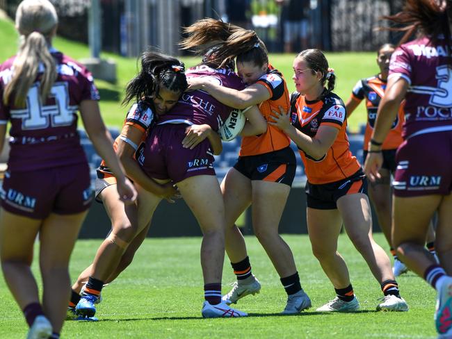 Ashanti Pennell (centre) hits hard in defence. Picture: Rhiannah Gebbie/Shot Of Guac Photography