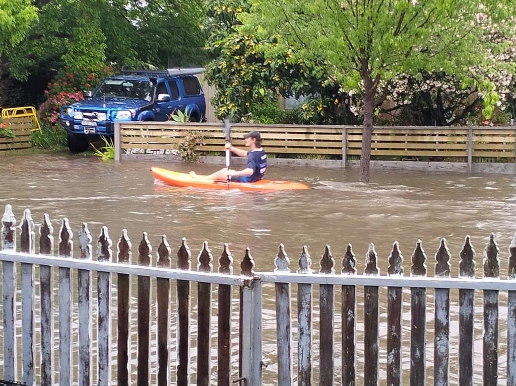 A man was captured kayaking down a flooded st. Picture: Facebook/Terese Wilby