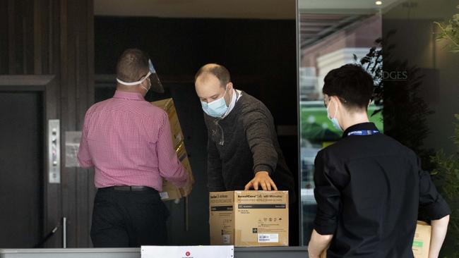 Staff at Rydges on Swanston hotel in Melbourne receive a delivery of PPE on Friday. Picture: David Geraghty/NCA NewsWire