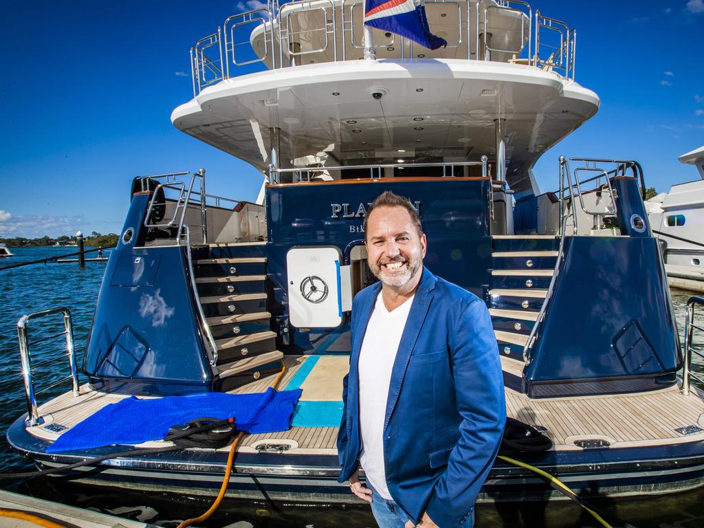 Aurora Global Logistics boss Jason Roberts in front of superyacht M/Y Playpen. Picture: NIGEL HALLETT