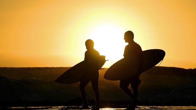 Surfers prepare to enter the water at Snapper Rocks on the Gold Coast.Picture: AAP