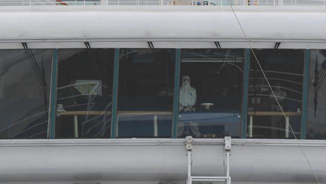 Hazmat suits on board the disease-stricken Ruby Princess as it leaves Port Kembla. Picture: Simon Bullard