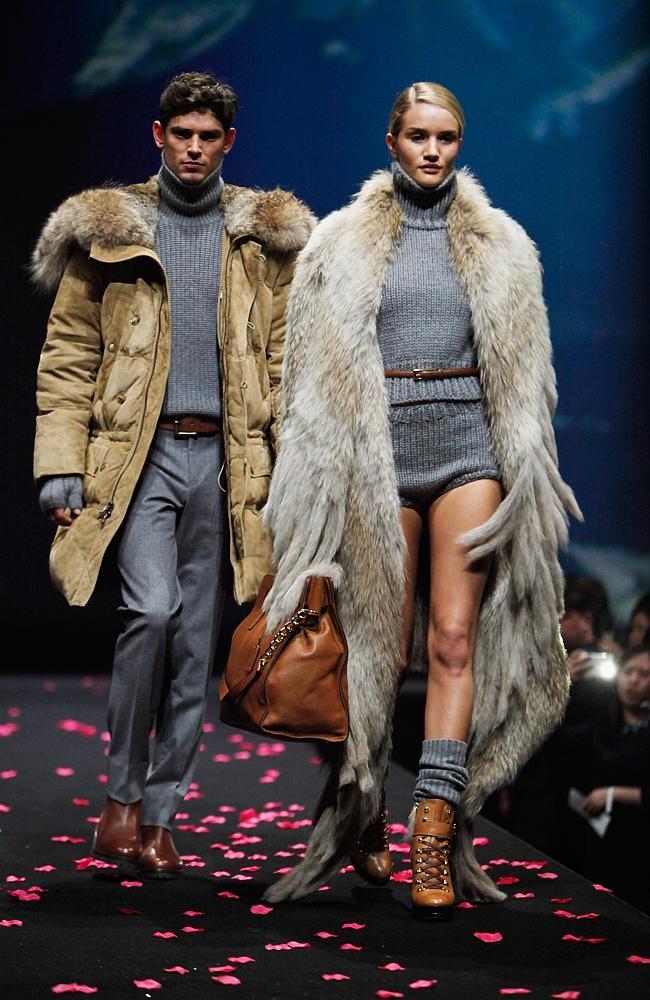  Rosie Huntington-Whiteley (R) and a male model walk on the catwalk during The Michael Kors Jet Set Experience fashion show on May 9, 2014 in Shanghai, China. 