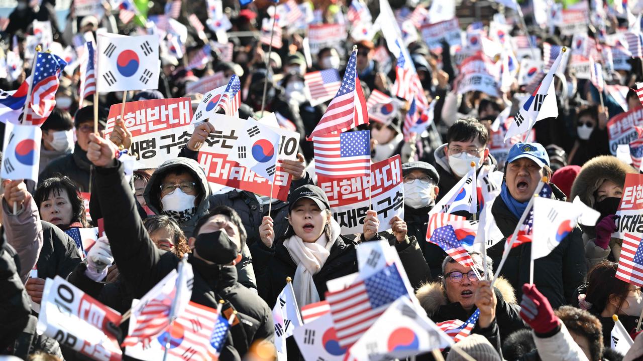 Supporters of impeached South Korea President Yoon Suk Yeol wave US and South Korean flags as they gather near the presidential residence in Seoul on December 31, 2024. Picture: Jung Yeon-Je/AFP