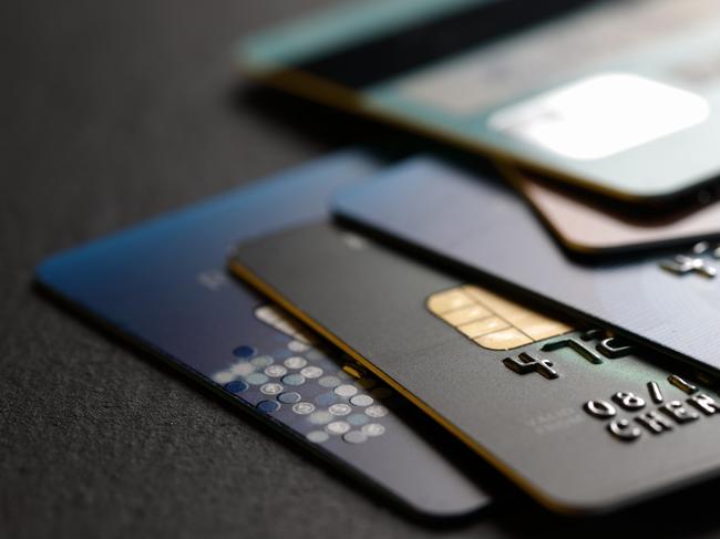 stack of multicolored credit cards on black background