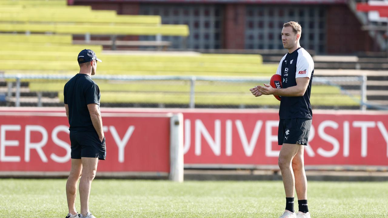 Harry McKay spoke to Blues fitness boss Andrew Russell (left) after a light running session and some set shot kicking on Thursday. Picture: Michael Willson / Getty Images