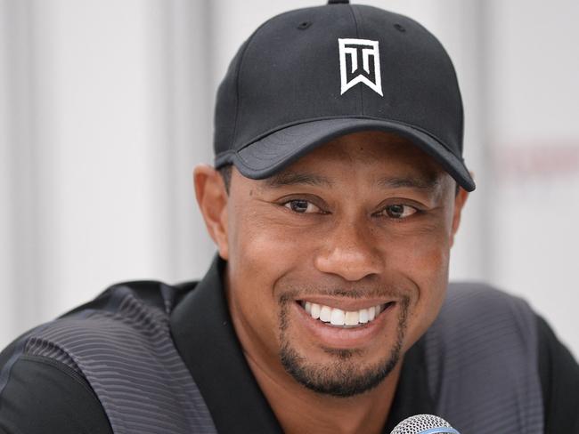 (FILES) In this file photo US golfer Tiger Woods smiles while speaking to the press at the Congressional Country Club in Bethesda, Maryland on June 24, 2014. - Tiger Woods was driving at nearly double the 45 mph speed limit when he crashed in California in February, Los Angeles County's sheriff said on April 7, 2021. Woods's SUV flew off the road at up to 87 miles (140 kilometers) an hour and flipped several times during the accident in Ranchos Palos Verdes, leaving the 45-year-old, 15-time major champion with a shattered right leg. (Photo by Mladen ANTONOV / AFP)