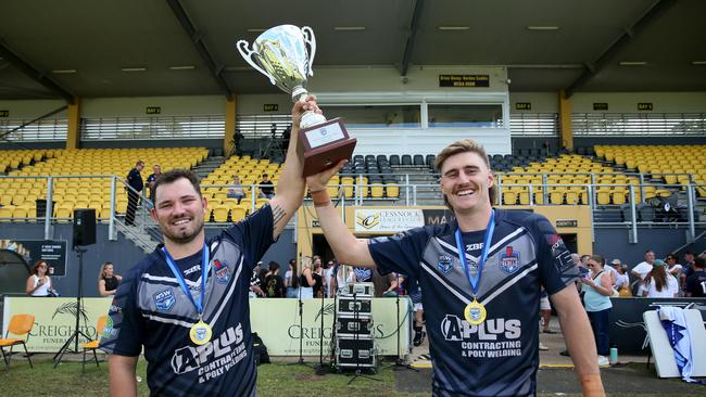 Newcastle skipper Chad O’Donnell and man of the match Cameron Anderson celebrate with the trophy. Picture: Sue Graham