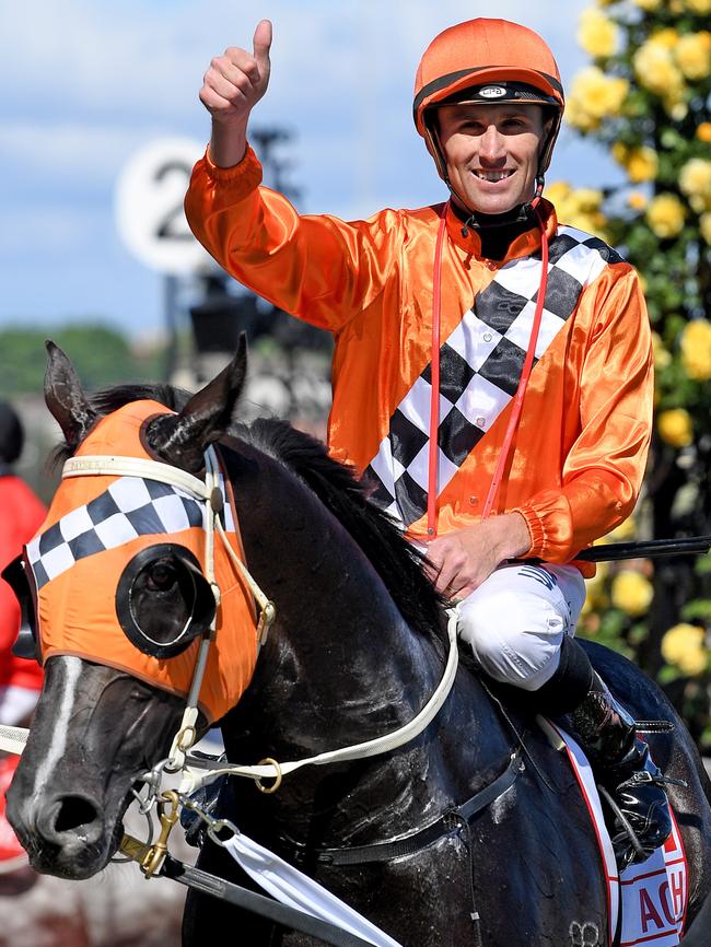 Jockey Tye Angland is all smiles after winning the 2017 Victoria Derby aboard Ace High. Picture: AAP