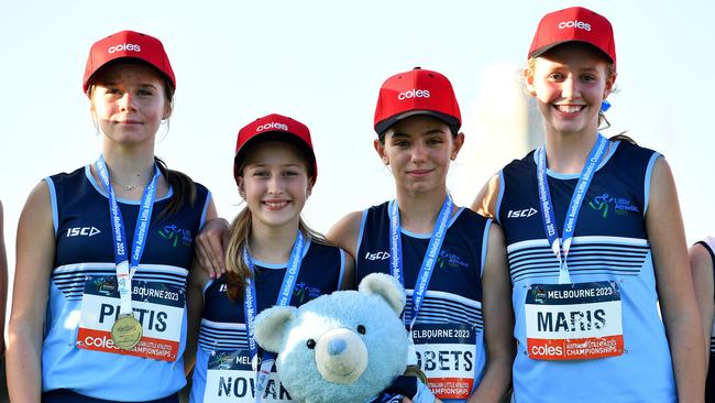 NSW’s Isla Maris, Siena Novak, Caitlin Probets and Adelaide Pittis pose on the podium at the 2023 Australian Little Athletics Championships.