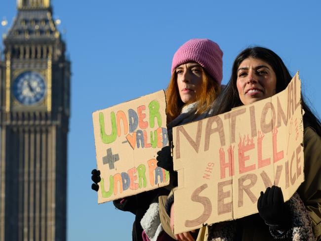 Nurses and supporters hold placards as they gather to demonstrate outside St Thomas' hospital in Westminster, London. Picture: Leon Neal/Getty Images
