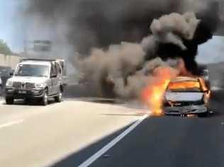 A  car was engulfed in flames after it overheated at Banora Point. Picture: Rick Koenig