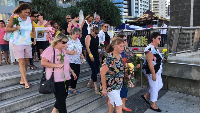 Family and friends arrive with flowers for the memorial to Ravneet Kaur at Surfers Paradise.