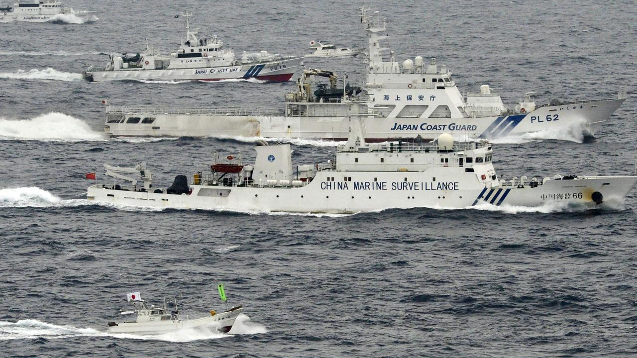 Two Japanese boats and the Japan Coast Guard sail alongside a Chinese surveillance ship near disputed islands in the East China Sea on April 23, 2013. Picture: Kyodo News/AP