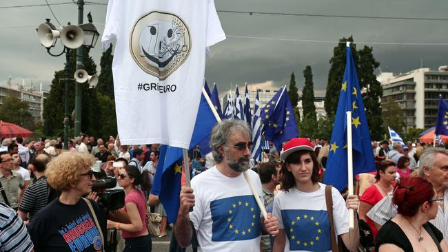 Protesters participate in a pro-euro demonstration in front of the parliament building in Athens. Thousands of people rallied in Athens on Tuesday in support of a bailout deal.