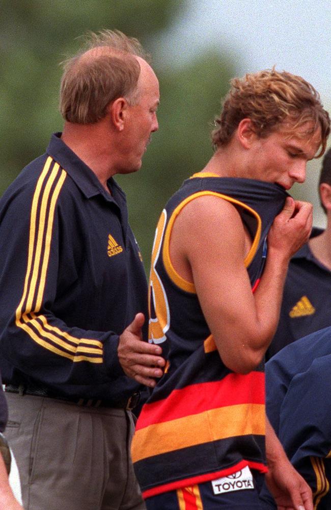 Malcolm Blight patting David Gallagher on the back. AFL football - Adelaide Crows verus North Melbourne practice match at Penola in 1999.