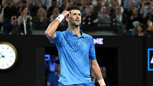 Novak Djokovic gestures as he celebrates victory in the men's singles final match against Stefanos Tsitsipas at the Australian Open. (Photo by MANAN VATSYAYANA / AFP) –