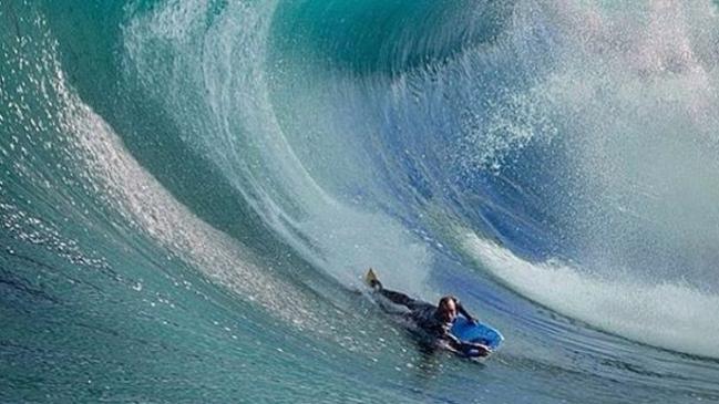 Jake Stone taking on a massive wave.