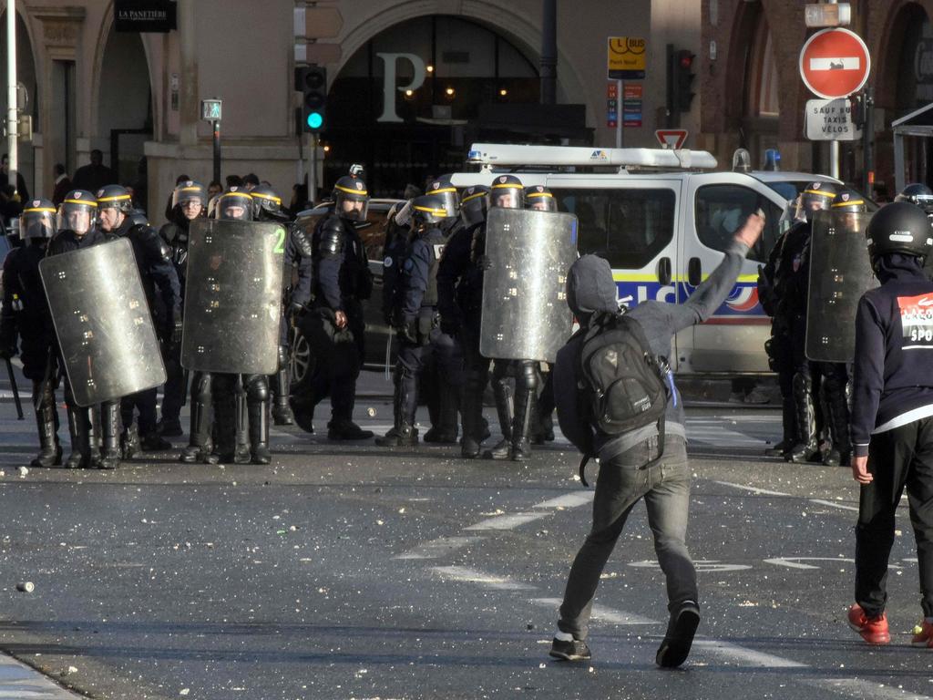 A man throws projectiles near the Pont Neuf, in Toulouse. Picture: Remy Gabalda/AFP