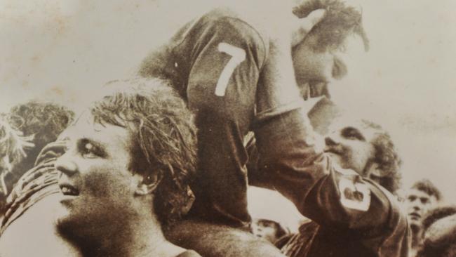 Wally Lewis, Ross Strudwick, and John McLeod celebrate the Valley's winning the 1979 grand final.
